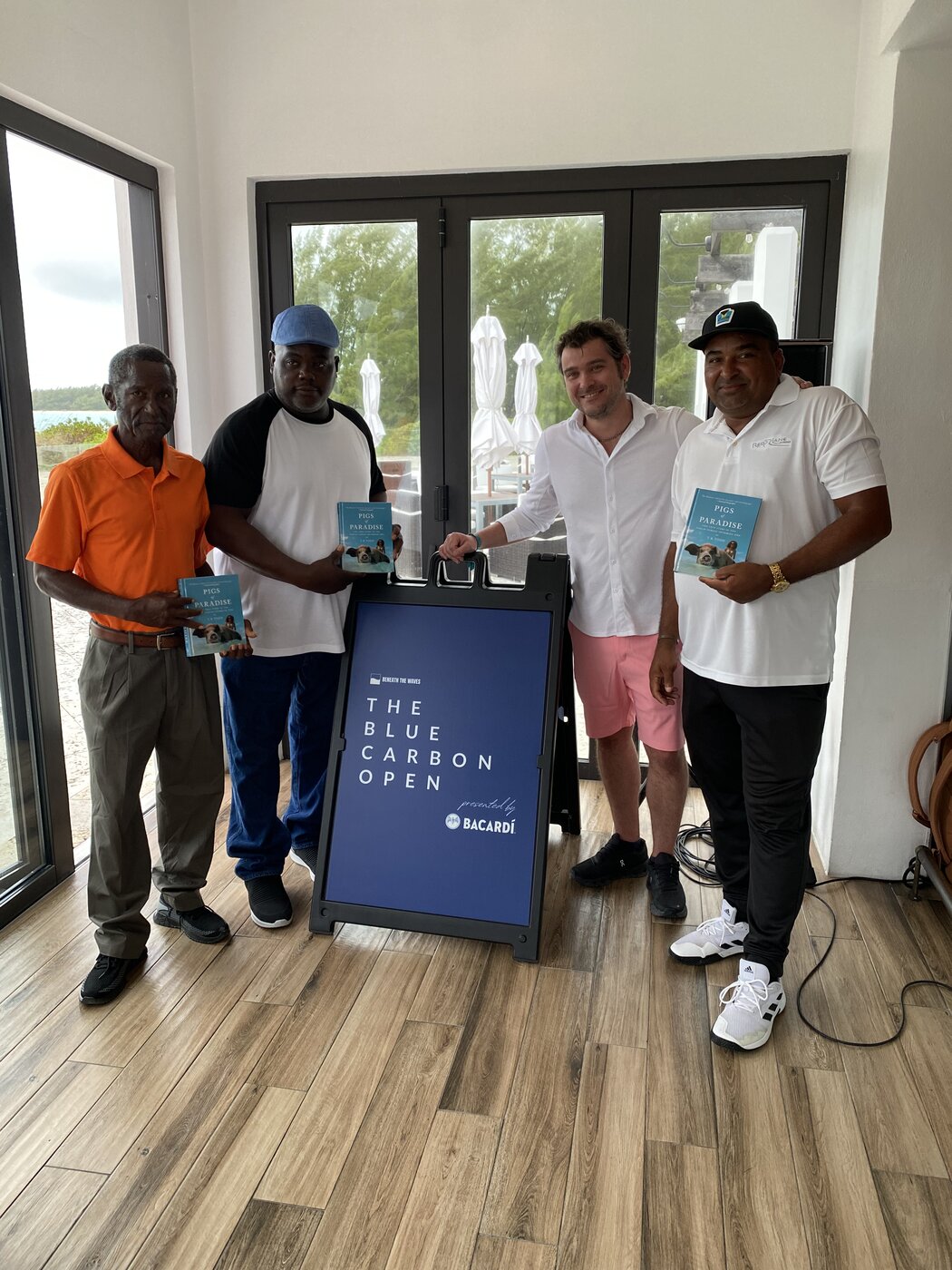 The Blue Carbon Open 2023 champions from Exumas Golf Federation with signage presented by Bacardí